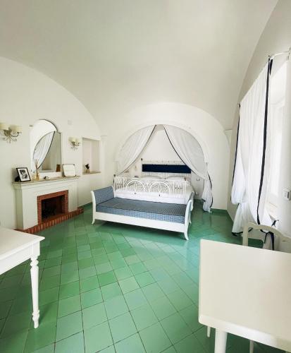 a bedroom with a white bed with a canopy at Villa Calypso in Capri