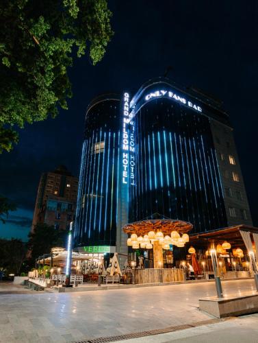 a building with blue lights on it at night at Grand Mildom Hotel in Almaty
