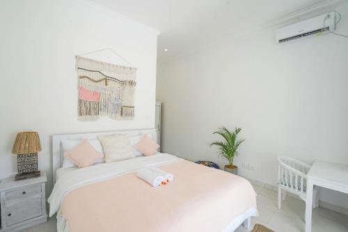 a bedroom with a bed with a towel on it at Sukacita Hill in Uluwatu