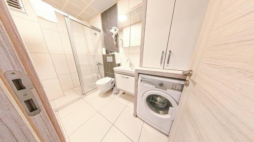 a bathroom with a washing machine and a toilet at Cozy flat close to Konyaaltı beach '6' in Antalya