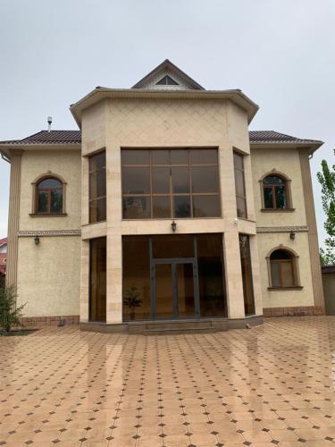 a large building with a lot of windows at STATUS in Shymkent