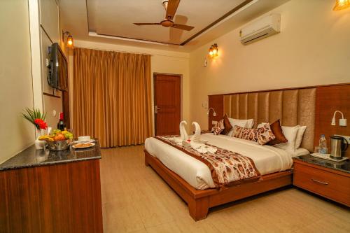 a bedroom with a large bed in a room at Excel Hotels and Resorts Bhimtal in Bhīm Tāl