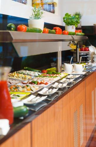 a buffet line with many different types of food at Villa Park Med. & SPA in Ciechocinek