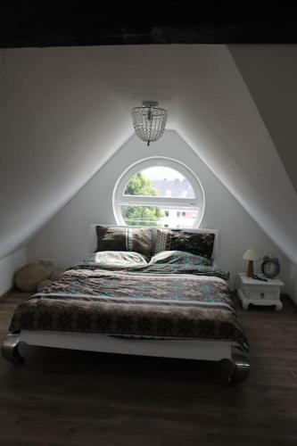 a bedroom with a bed with a large window at Ferienwohnung Luna in Trier