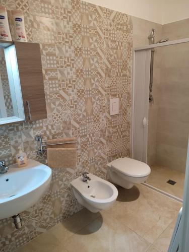 a bathroom with a sink and a toilet at Le Casette di Adele in Palagiano