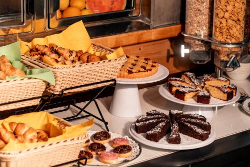a bunch of different types of pastries on a counter at K MODERN HOTEL in Peschiera del Garda