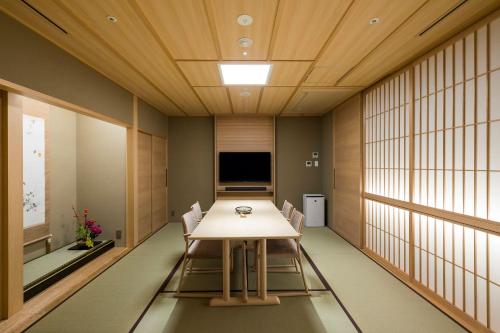 a conference room with a table and chairs in it at Kinzan in Kobe