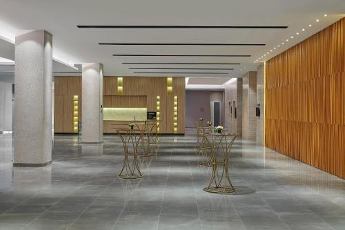 a lobby with chairs and tables in a building at Courtyard by Marriott Melaka in Melaka