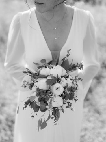 a woman holding a bouquet of white flowers at Hotel des Glücks - Landhotel Fischl in Sankt Oswald