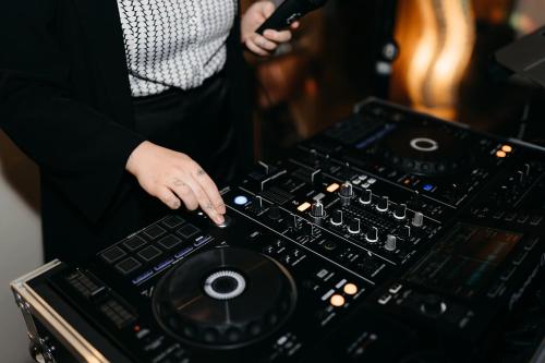 a woman is standing in front of a mixing console at Hotel des Glücks - Landhotel Fischl in Sankt Oswald
