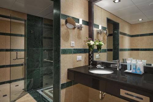 a bathroom with a sink and a shower at Bisila Palace in Ciudad de Malabo