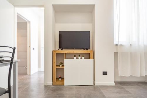 a living room with a television on a cabinet at KHL APARTMENTS - SanSiro, Milano in Milan