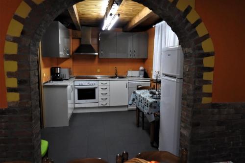 - une cuisine avec des appareils blancs et un mur en briques dans l'établissement PUENTECUERVO, à Pancorbo