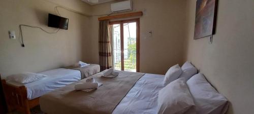 Postel nebo postele na pokoji v ubytování Villa Froso