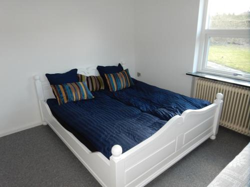 Un pat sau paturi într-o cameră la Kummelefort