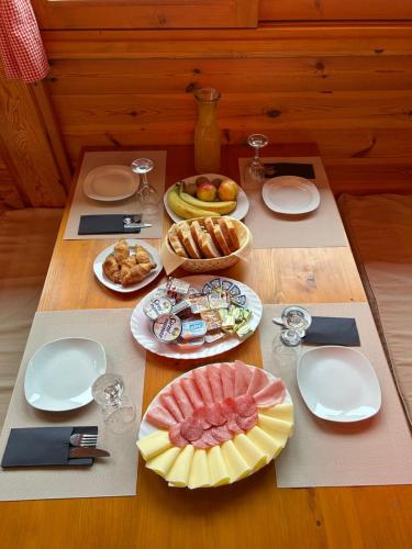 a table with plates of food on top of it at Apartments Zafran in Smoljanac