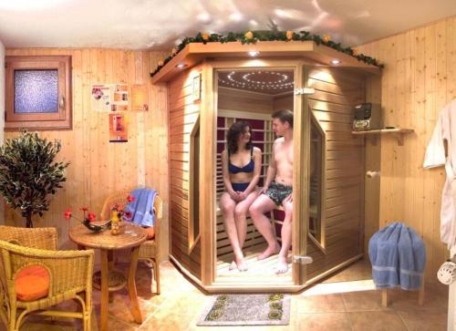 um homem e uma mulher sentados numa sauna em Urlaub-im-Haus-Nietmann-FW-2 em Altenau