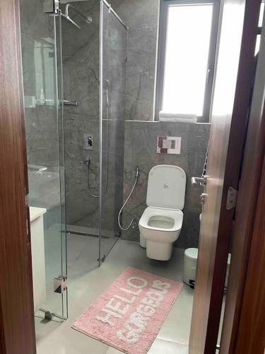 a bathroom with a toilet and a glass shower at Solaris Premium Luxury Living in Accra