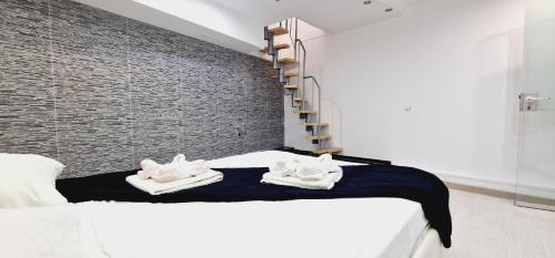 a bedroom with a bed and a brick wall at ELEGANT 3 BEDROOMS, Wifi free in Adeje