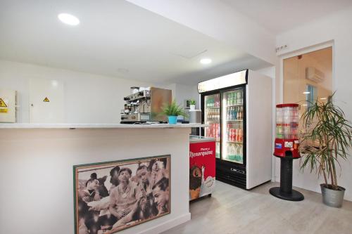 a restaurant with a refrigerator and a picture on the counter at Hotel Boogaloo - Adults Only in El Arenal