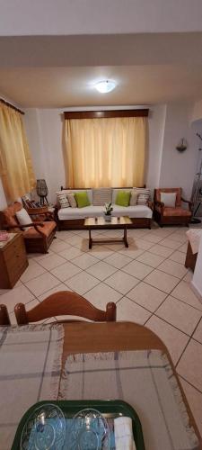 a living room with a couch and a table at Loula's House in Spetses