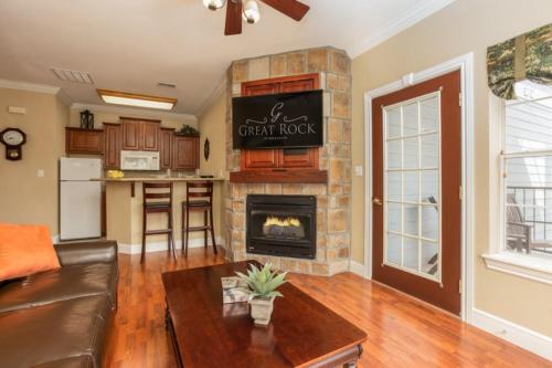 a living room with a couch and a fireplace at Branson's Great Rock Retreat in Branson