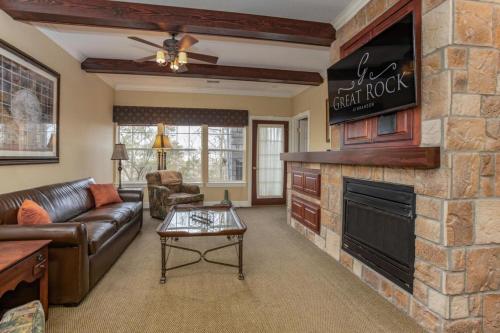 a living room with a couch and a fireplace at Branson's Great Rock Retreat in Branson