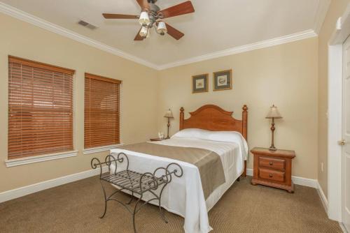 a bedroom with a bed and a ceiling fan at Branson's Great Rock Retreat in Branson