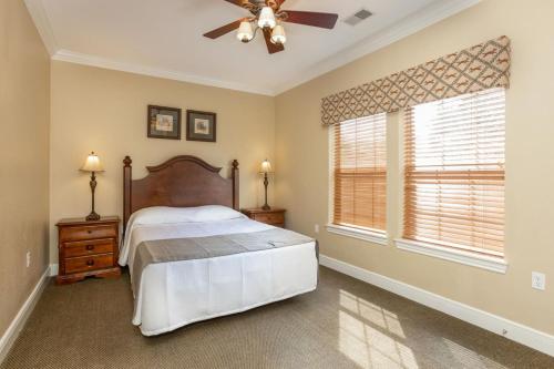 a bedroom with a bed and a ceiling fan at Branson's Great Rock Retreat in Branson