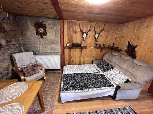een slaapkamer met een bed en een stoel in een kamer bij U myslivce in Chřibská