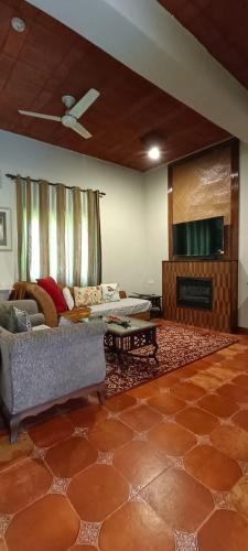 a living room with a couch and a flat screen tv at Ranjit's Svaasa Amritsar in Amritsar