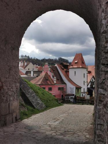 a view of a town from an archway in a city at Apartmán s terasou a výhledem na jezero Lipno in Kovářov