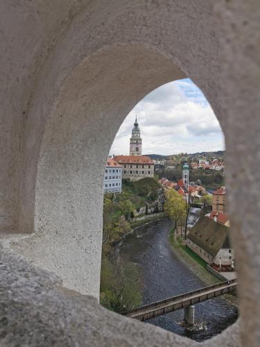a view of a river from a stone bridge at Apartmán s terasou a výhledem na jezero Lipno in Kovářov