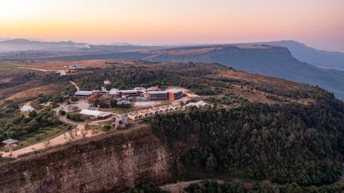 an aerial view of a building on the edge of a mountain at Angels View Hotel in Graskop