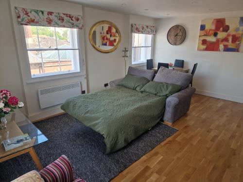 a living room with a bed and a couch at The Bank in Lewes