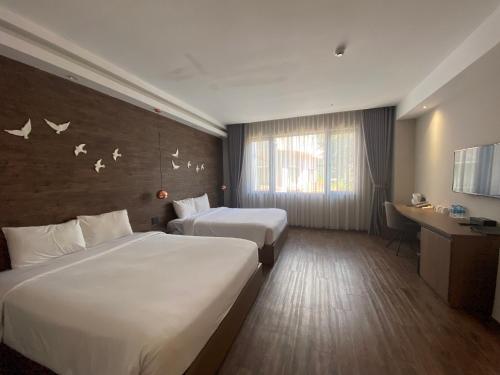 Giường trong phòng chung tại The Luxe Da Lat