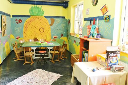 a dining room with a table and a large pineapple on the wall at Familienparadies Reichenhauser in Keutschach am See