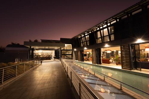 a building with a swimming pool at night at Angels View Hotel in Graskop
