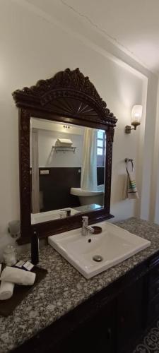 a bathroom with a sink and a mirror on a counter at Ranjit's Svaasa Amritsar in Amritsar