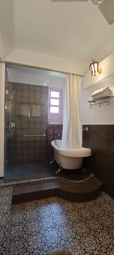 a bathroom with a large tub and a shower at Ranjit's Svaasa Amritsar in Amritsar