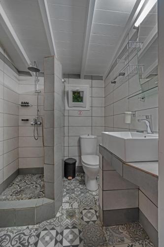a bathroom with a sink and a toilet at Amouage Boutique Home in Skiathos Town