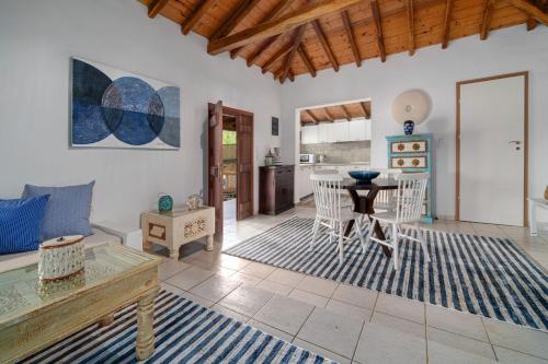 a living room with a table and a kitchen at Amouage Boutique Home in Skiathos Town