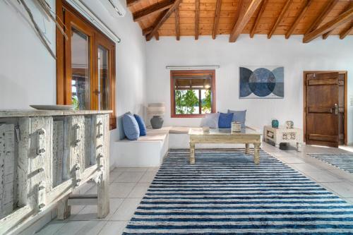 a living room with a couch and a table at Amouage Boutique Home in Skiathos Town