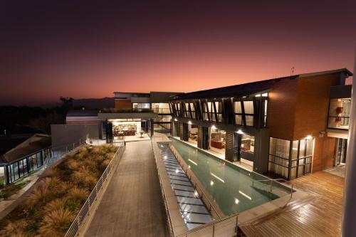 an exterior view of a building with a swimming pool at Angels View Hotel in Graskop