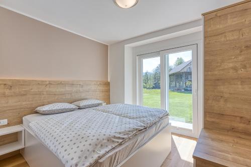 a bedroom with a bed and a large window at Relax House Nizka Savinja - Happy Rentals in Rečica ob Savinji
