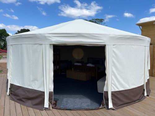 a white tent sitting on a wooden deck at Dukeries Retreat in Retford