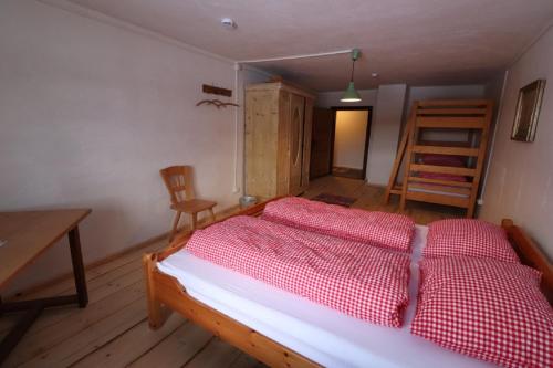 a bedroom with a bed and a table and a chair at Haidhäusl in Haidmühle