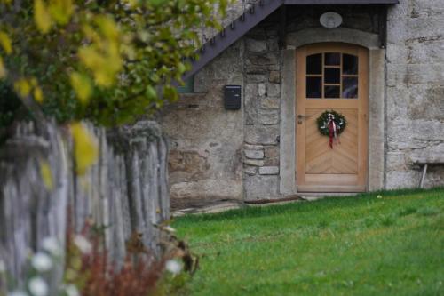 a door of a stone building with a wreath on it at Haidhäusl in Haidmühle
