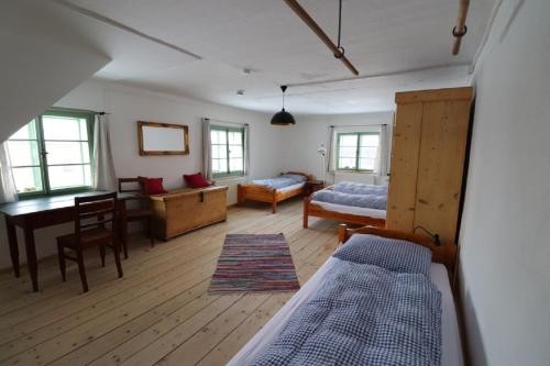 a bedroom with a bed and a desk and a table at Haidhäusl in Haidmühle