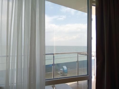 a view of the ocean from a room with a window at СЛЪНЧЕВ ЗАЛИВ in Pomorie